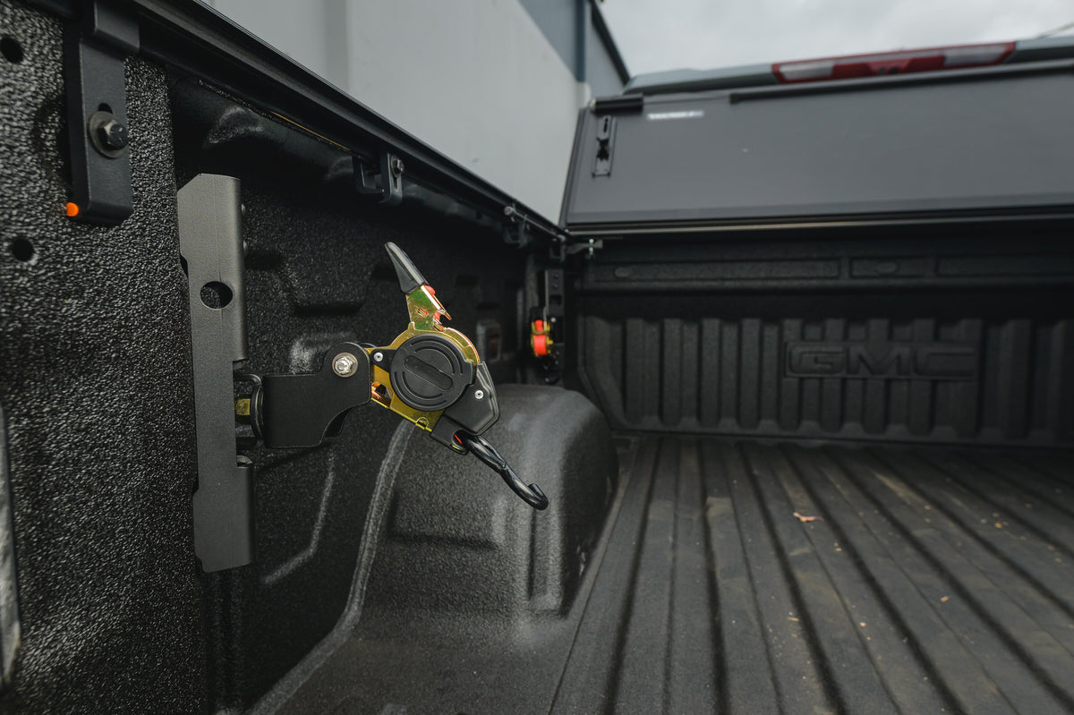Ultimate Retractable Ratchet Strap on the Chevy/GMC 2019+ mount pivoted out from the bed wall
