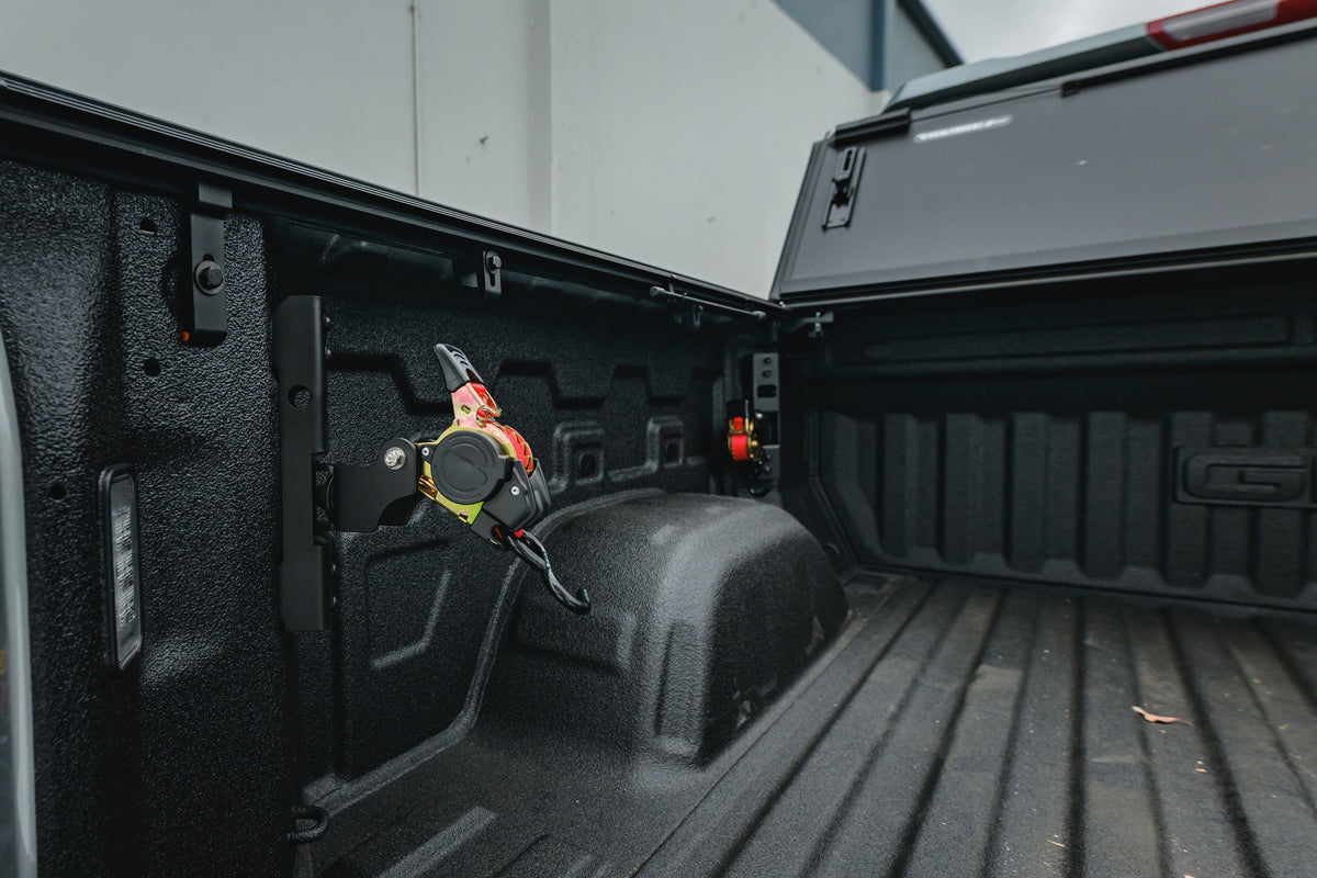 Ultimate Retractable Ratchet Strap stowed on the Chevy/GMC 2019+ mount in a Sierra bed