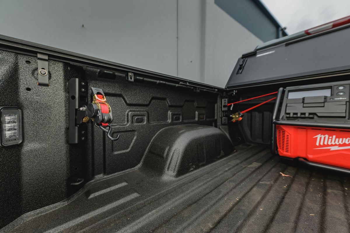 Ultimate Retractable Ratchet Strap securing a Milwaukee Packout radio in a GMC Sierra bed