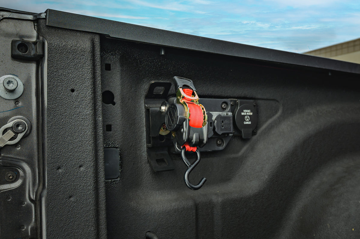 Ultimate Retractable Ratchet Strap stowed on the RAM 2019+ mount beside the in-bed power panel